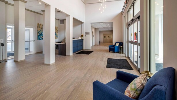 A spacious lobby with a reception desk, seating area, and large windows. - The Inn at Leonardtown, an Ascend Collection Hotel (Leonardtown)