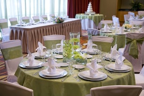 A banquet hall with round tables set for a formal event, complete with white tablecloths, folded napkins, and glassware. - Embassy Suites by Hilton Houston Energy Corridor (Houston)
