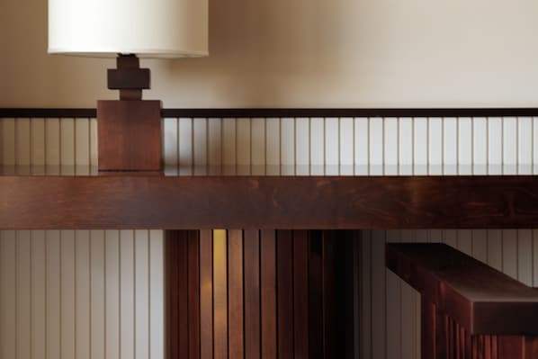 A wooden bench with a lamp on it.