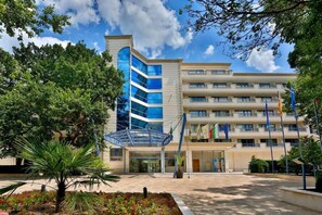 A modern hotel with a glass facade, multiple balconies, and a central atrium. - Sofia (Golden Sands)
