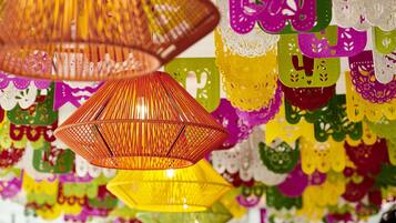 A room with hanging paper lanterns and colorful paper decorations.