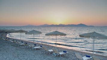 On the beach, sun loungers, beach umbrellas, beach towels