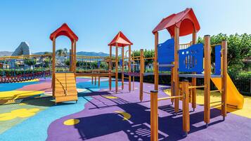 A playground with climbing structures and slides.