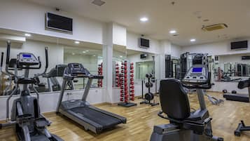 A gym with treadmills, ellipticals, and weight machines.