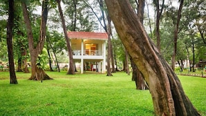 A two-story building with a red roof, surrounded by a grassy area and trees. - VGP Golden Beach Resort (Chennai)