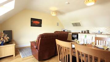 Deluxe Apartment, 2 Bedrooms | Living area | Flat-screen TV
