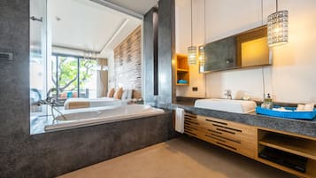 Un baño moderno con una bañera grande, un lavabo doble y un espejo amplio.