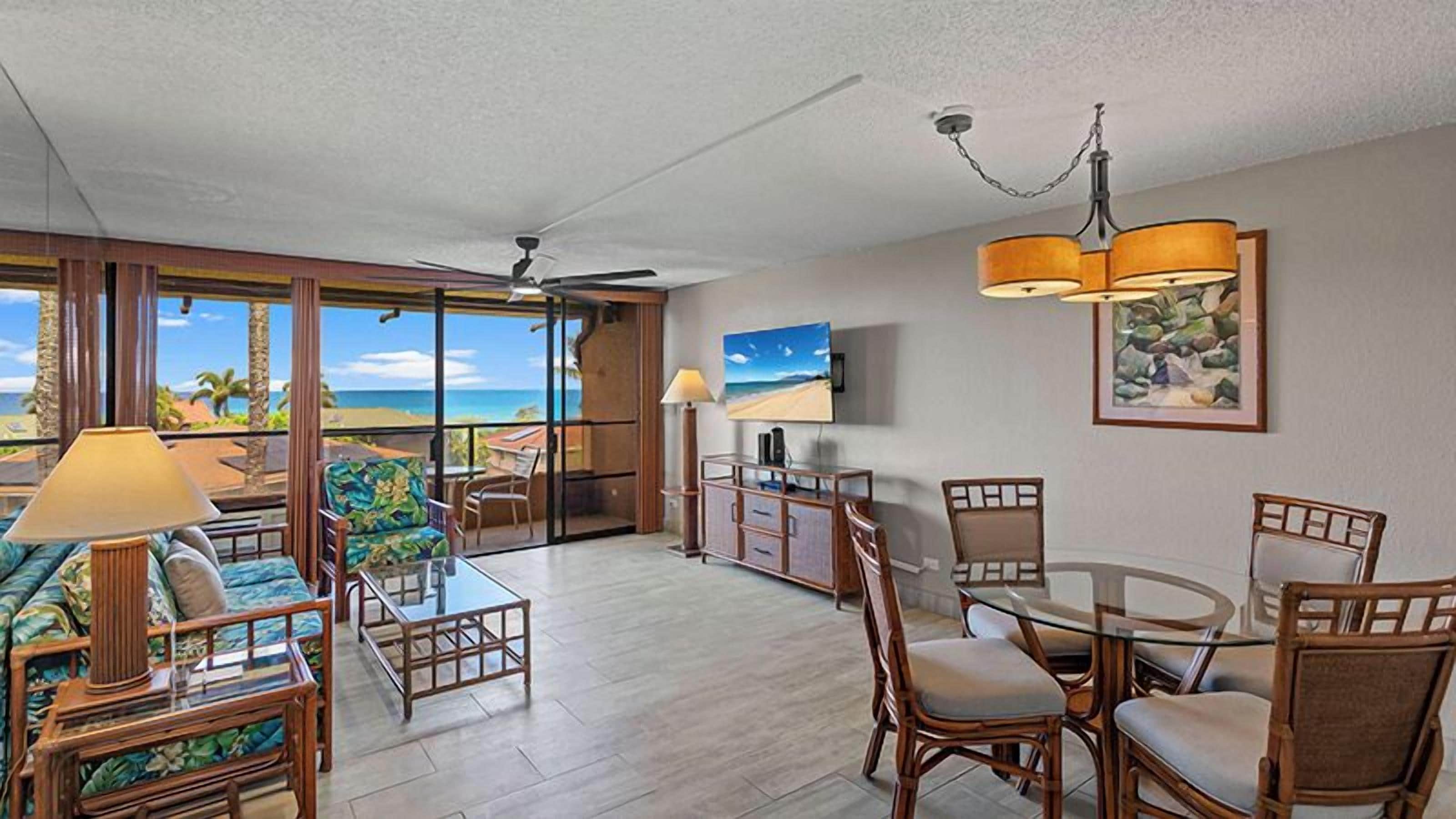 A spacious living area with a balcony, a dining table, and chairs.
