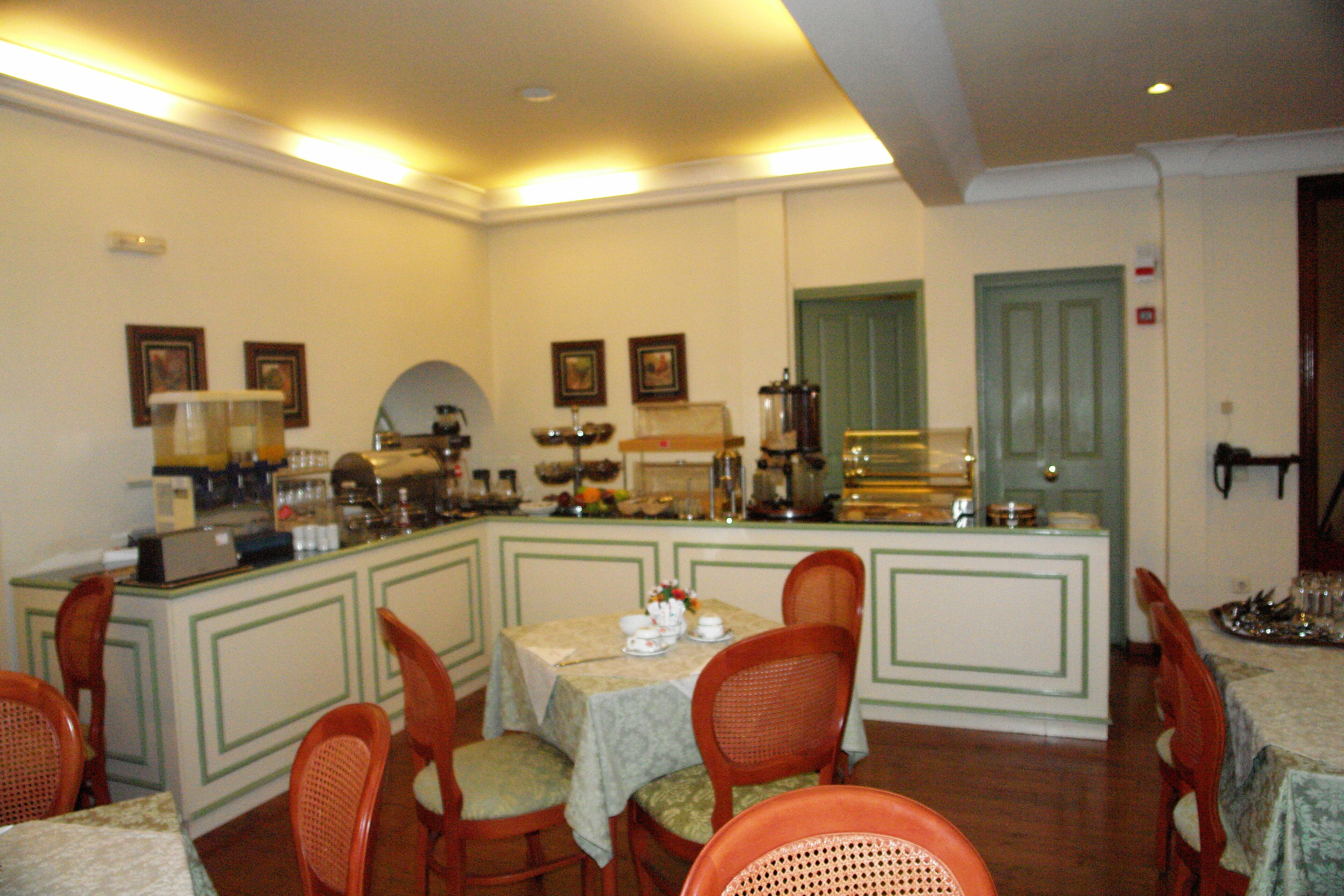 A dining area with a counter, chairs, and a table set for a meal.