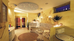 A bathroom with a checkered mosaic sink, a round mirror, and a small round table with a woven base.