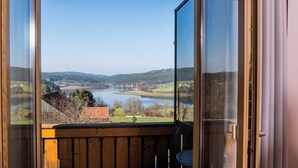 A balcony with a view of a river and a bridge.