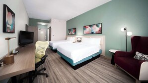 A hotel room with two beds, a desk with a computer, a chair, a red armchair, and artwork on the walls. - Hilton Garden Inn Houston/Clear Lake NASA (Webster)