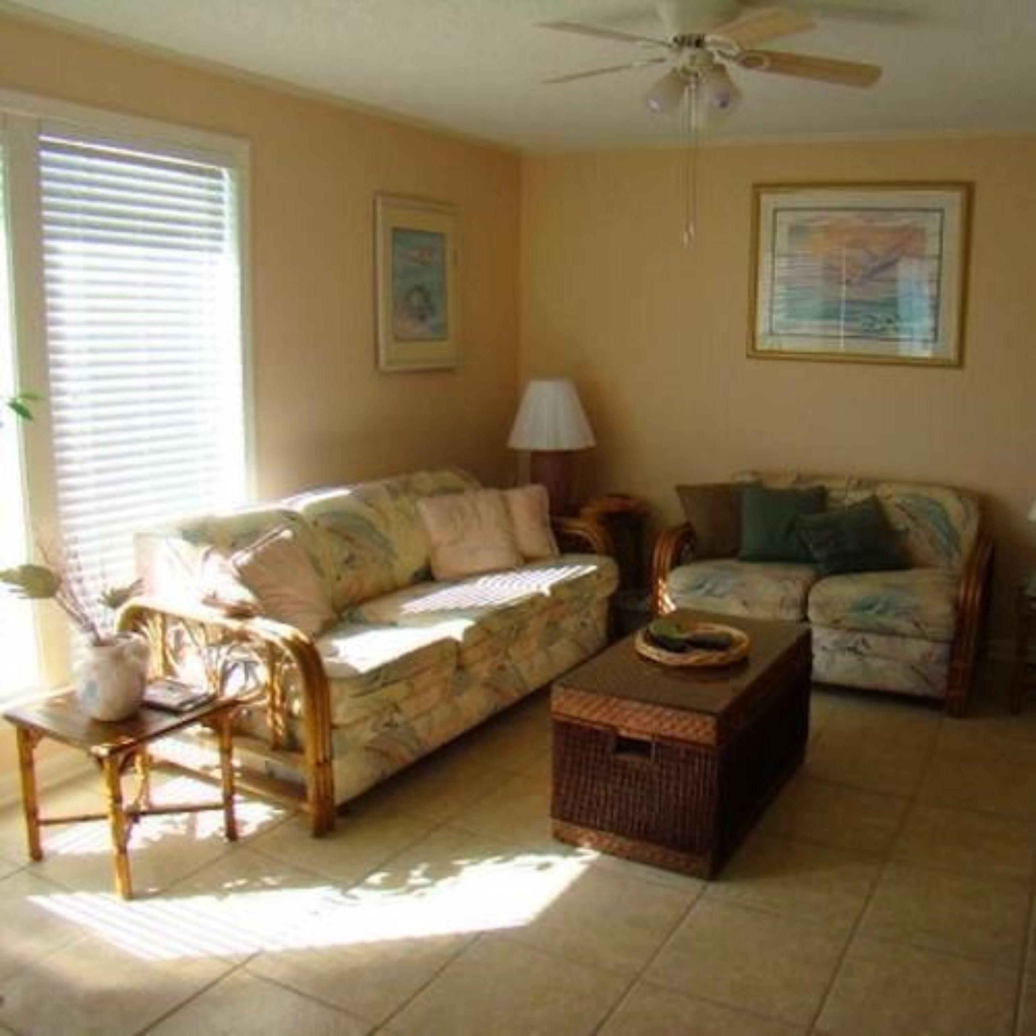 A living room with two sofas, a coffee table, and a floor lamp.
