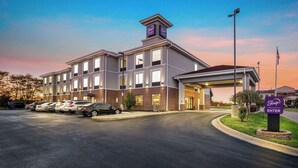 A hotel with a parking lot, a covered entrance, and a sign indicating the entrance. - Sleep Inn & Suites Dyersburg I-155 (Dyersburg)