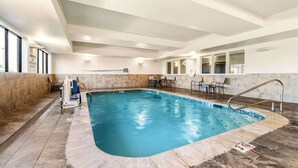 An indoor swimming pool with a tiled floor, a lifeguard chair, and a sign indicating no lifeguard on duty. - Sleep Inn & Suites Dyersburg I-155 (Dyersburg)