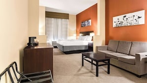 A hotel room with a bed, a sofa, a desk, and a coffee maker. - Sleep Inn & Suites Dyersburg I-155 (Dyersburg)