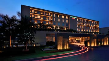 Welcome to our hotel, featuring a beautifully landscaped courtyard with a tranquil fountain.