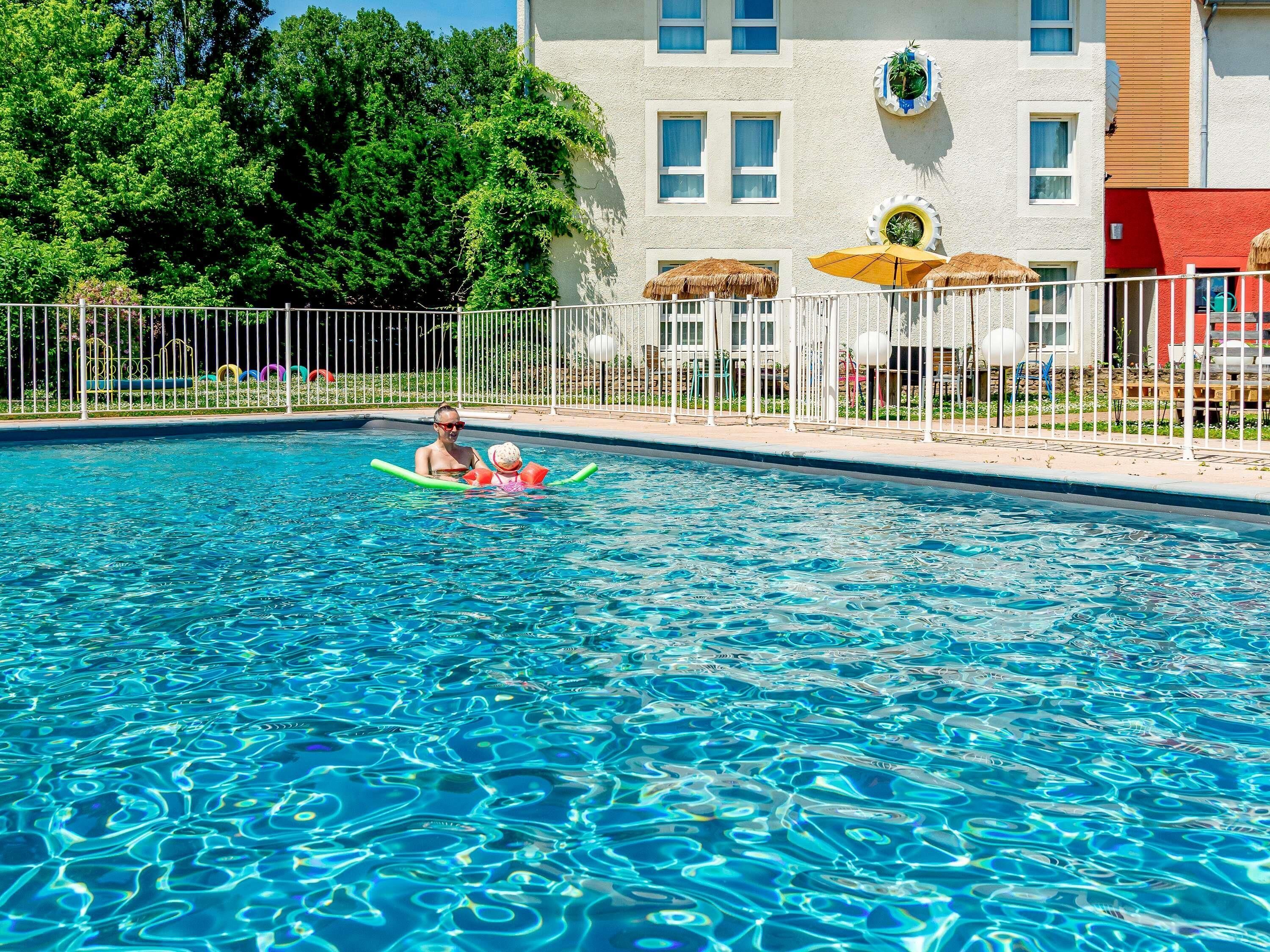 Seasonal outdoor pool, open 9:30 AM to 9:30 PM, pool umbrellas