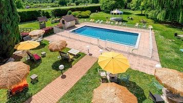 Seasonal outdoor pool, open 9:30 AM to 9:30 PM, pool umbrellas