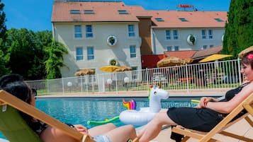 Seasonal outdoor pool, open 9:30 AM to 9:30 PM, pool umbrellas