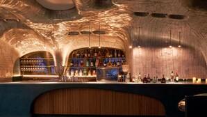 A bar with a brick wall and a wooden counter. - Silverland Ben Thanh (Ho Chi Minh City)