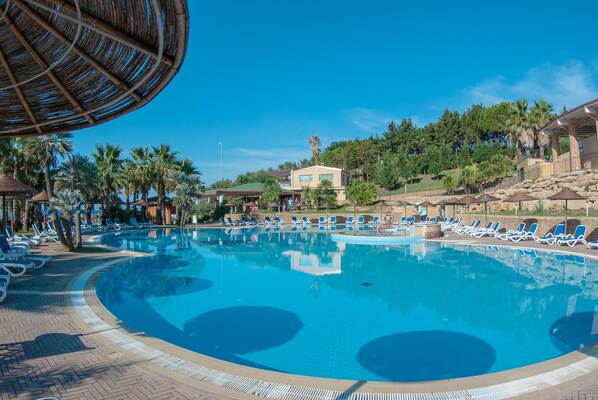 季节性开放的室外游泳池,池畔遮阳伞,日光浴躺椅