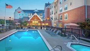 A hotel with a swimming pool, outdoor seating, and a brick facade. - Residence Inn by Marriott Waldorf (Waldorf)