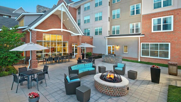 A patio area with outdoor seating, a fire pit, and a poolside bar. - Residence Inn by Marriott Waldorf (Waldorf)