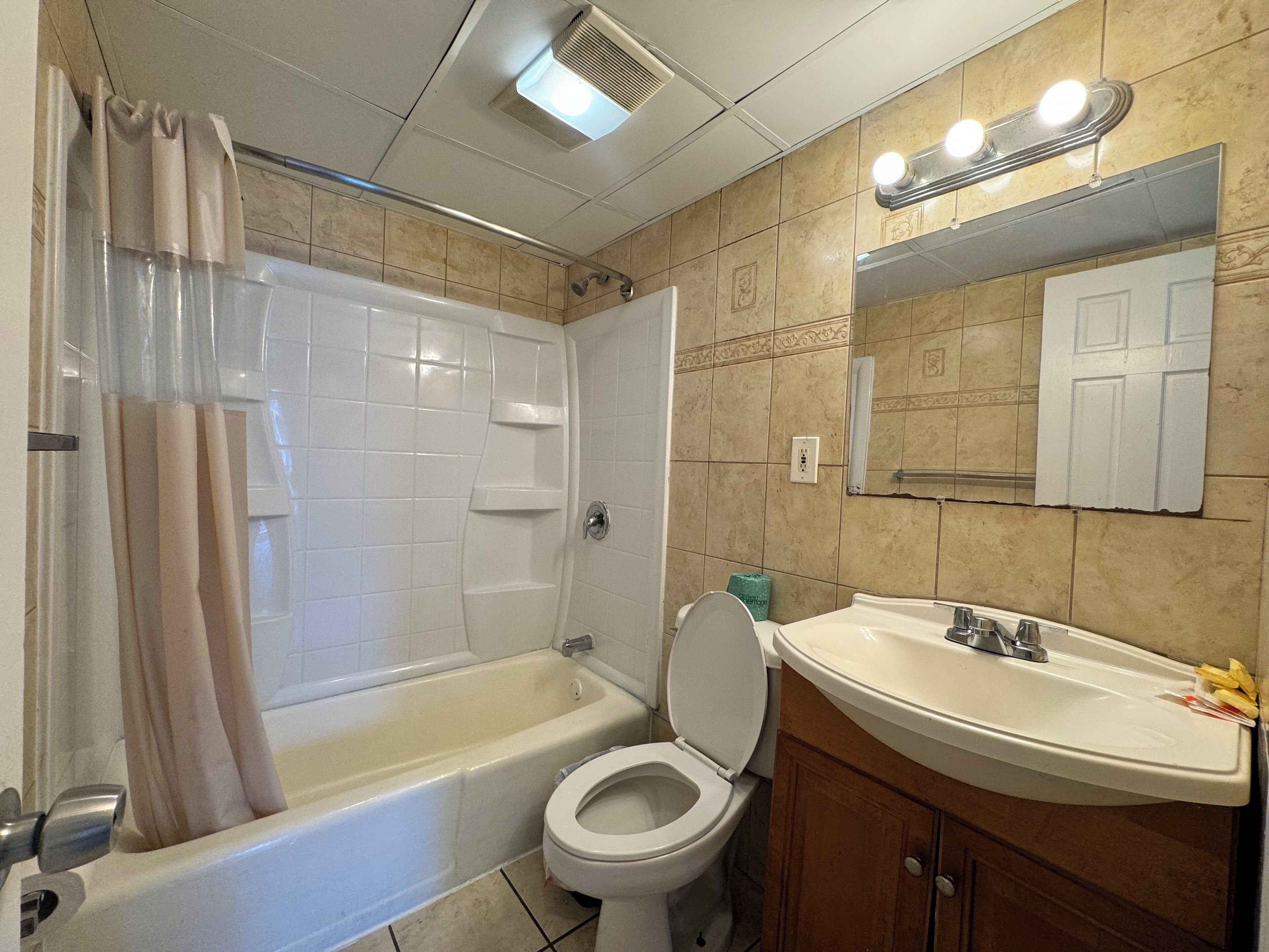 A bathroom with a bathtub, toilet, and sink.