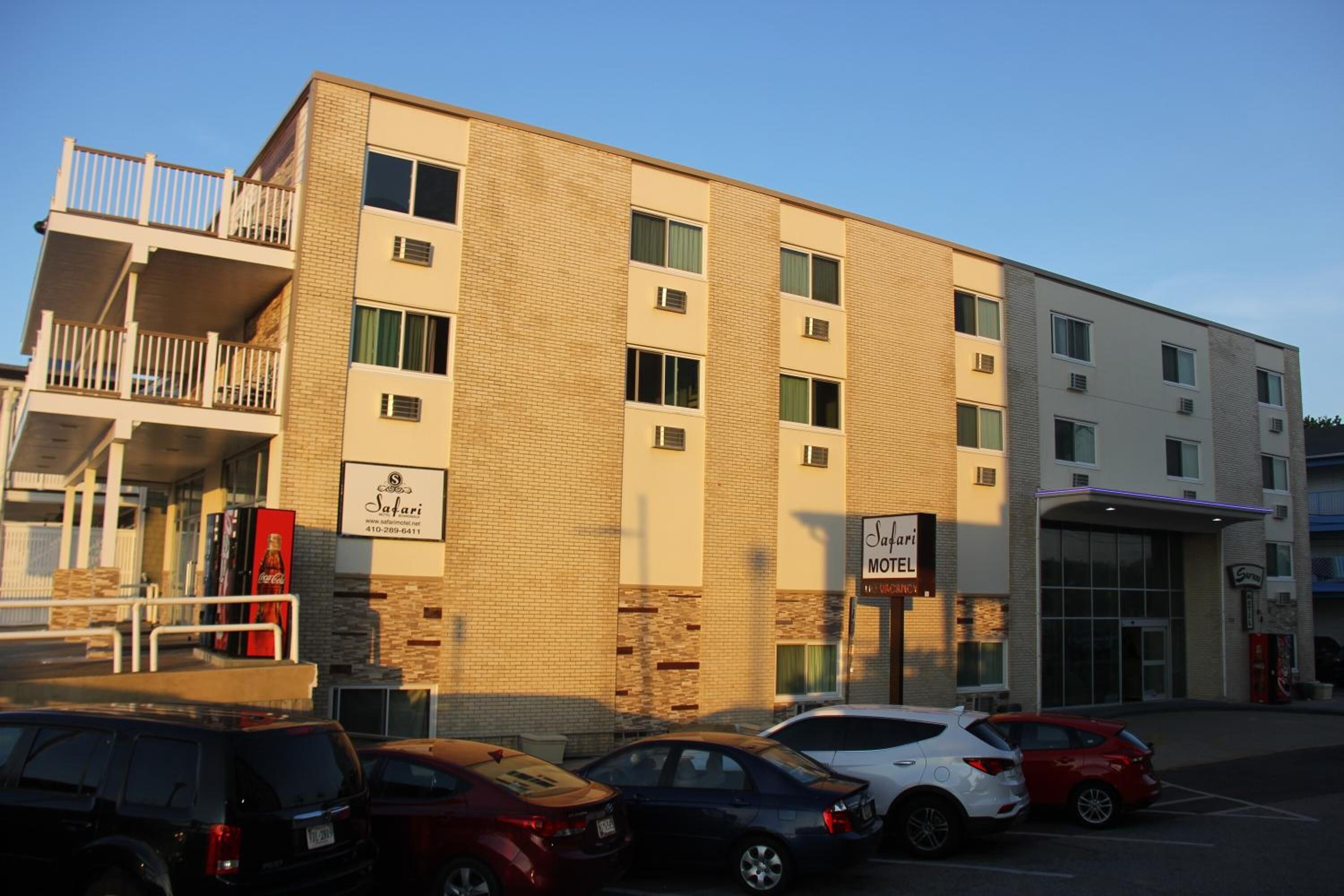 A multi-story building with a brick facade, a visible ground floor entrance, and a sign for a Safari Motel.