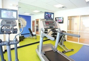 Stay active with our fully equipped fitness center featuring treadmills and a stationary bike with digital displays.