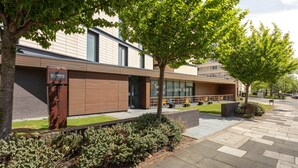 A modern building with a Staybridge Suites sign, outdoor seating, and a well-maintained garden area. - Staybridge Suites Newcastle by IHG (Newcastle-upon-Tyne)