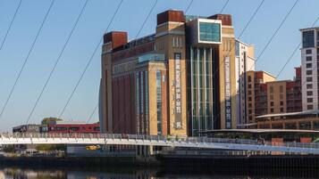 A modern building with large windows and a sign for 'Baltic Flow'.
