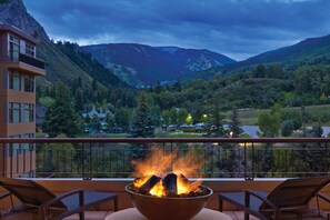 A balcony with a fire pit, overlooking a mountainous landscape with trees and buildings in the background. - The Westin Riverfront Mountain Villas, Beaver Creek Mountain (Avon)