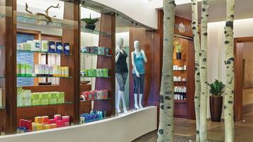Un centro de spa y bienestar con una zona de recepción, exhibición de productos de bienestar y una planta en el vestíbulo.