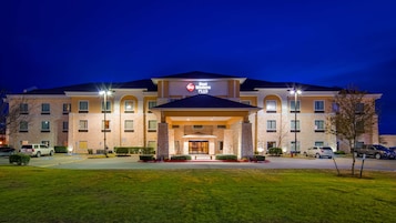 A Best Western Plus hotel with a stone facade, multiple windows, and a well-lit entrance.