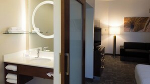 A hotel bathroom with a large mirror, a double sink, and a glass shelf with towels. - SpringHill Suites by Marriott Quakertown (Quakertown)