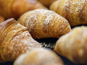 A close-up of several pastries dusted with powdered sugar. - Hotel ibis Friedrichshafen Airport Messe (Friedrichshafen)