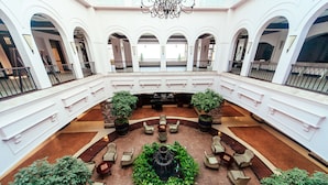 A spacious lobby with a central fountain, surrounded by seating areas and potted plants. - Lake Victoria Serena Golf Resort & Spa (Kampala)