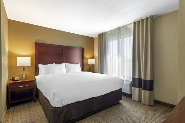 Premium bedding, desk, laptop workspace, blackout curtains