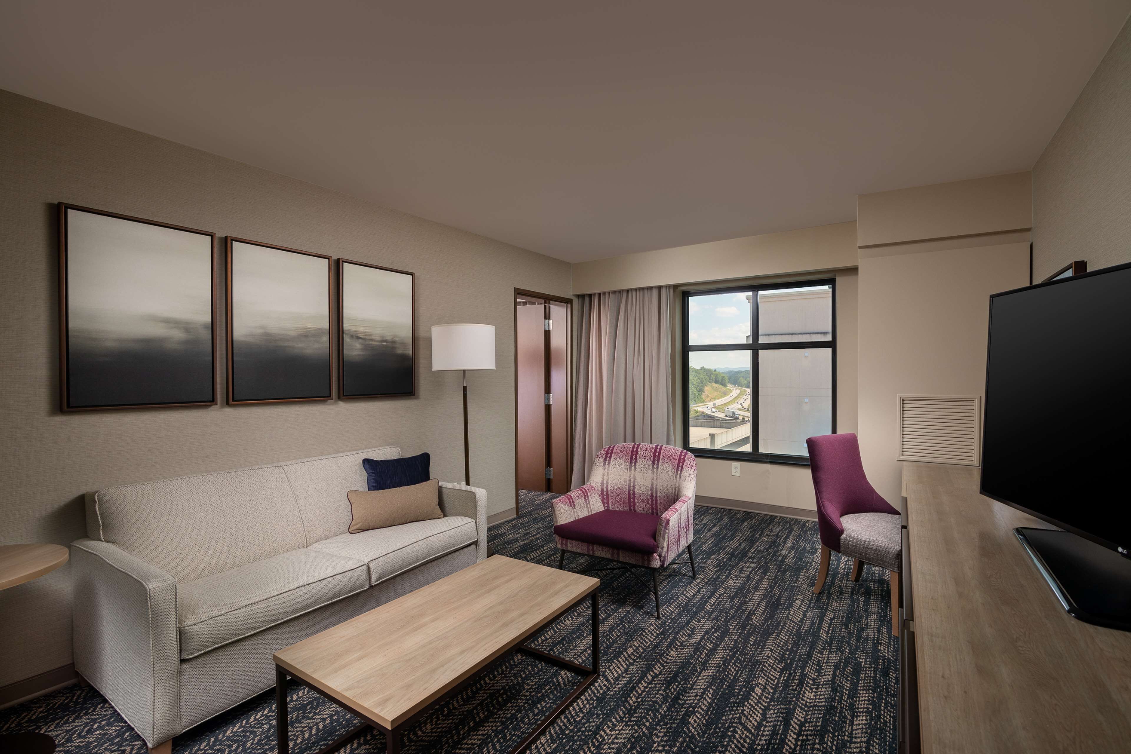 king bed bedroom suite | in-room safe, desk, laptop workspace, blackout curtains