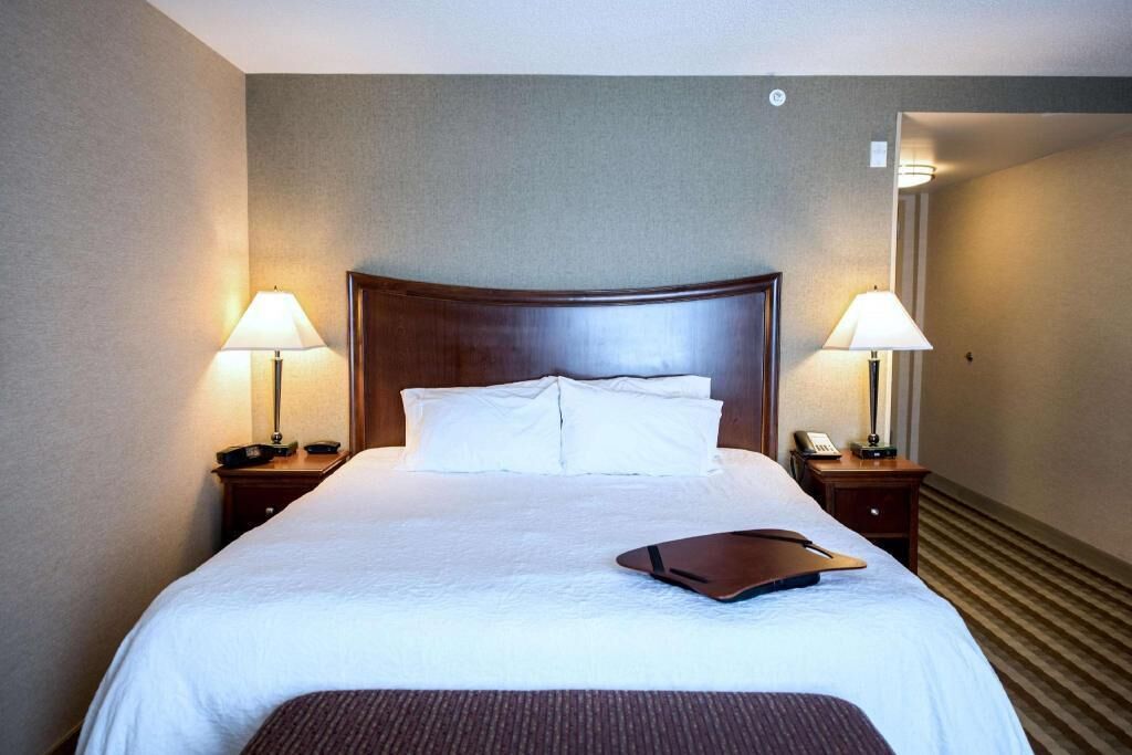 Hypo-allergenic bedding, desk, laptop workspace, blackout drapes