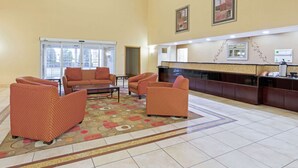 A spacious lobby with a reception desk, seating area with sofas, and a patterned rug. - La Quinta Inn & Suites by Wyndham Stillwater-University Area (Stillwater)