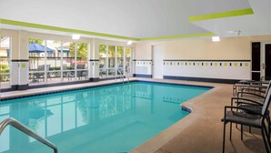A swimming pool with clear blue water, surrounded by lounge chairs and a covered seating area. - Fairfield by Marriott Inn and Suites Augusta Fort Eisenhower Area (Augusta)