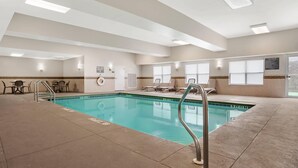 An indoor swimming pool with clear water, a metal ladder, and lounge chairs by the poolside. - Comfort Inn & Suites Dothan Northside Plaza (Dothan)