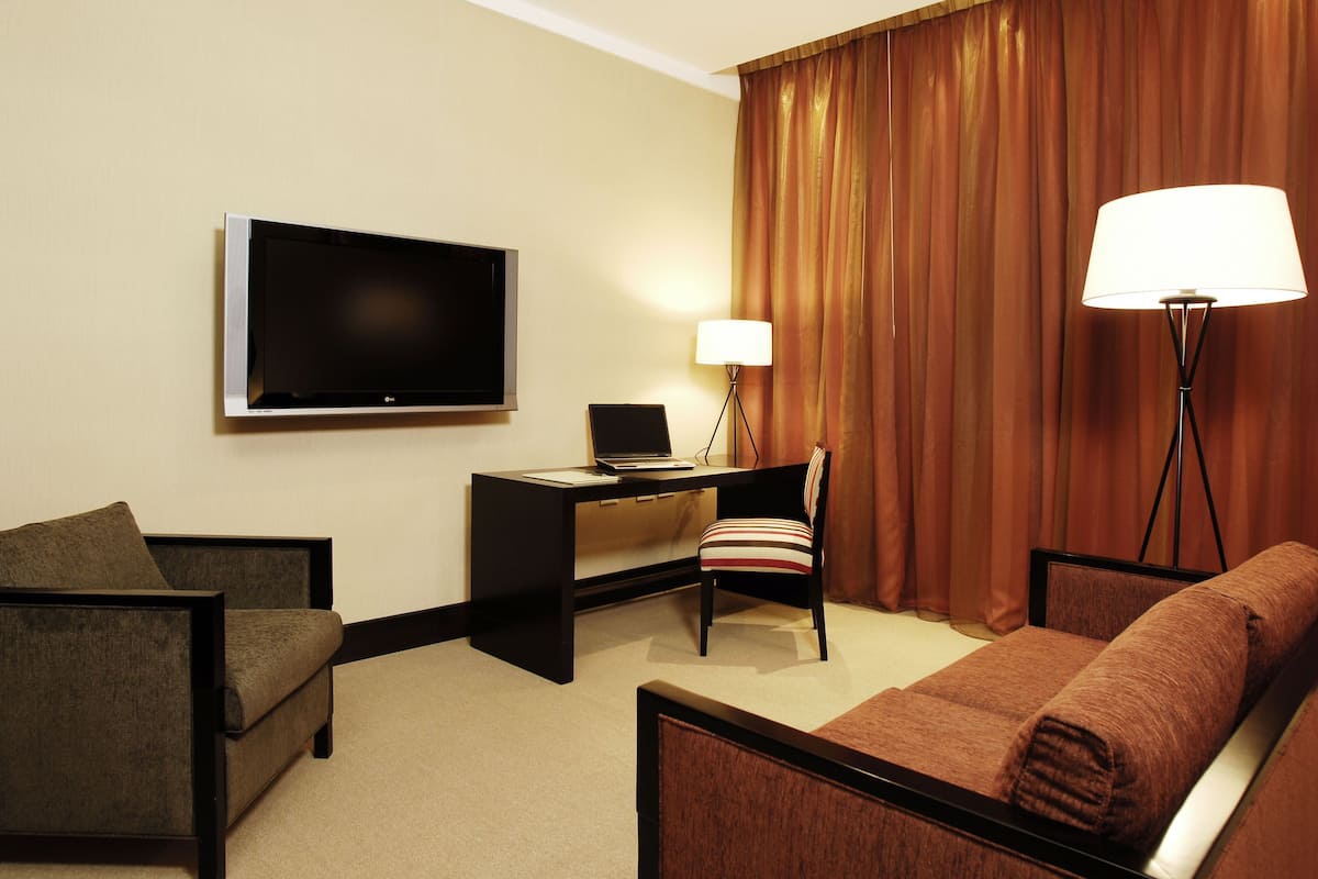 superior double room, 2 double beds, garden view, garden area | living area | 42-inch lcd tv with cable channels, tv