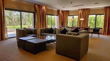 Presidential Studio Suite | Living area | 42-inch LCD TV with cable channels, TV
