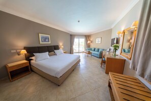 A hotel room with a large bed, a sofa, a desk, and a mirror. - Aurora Oriental Resort Sharm El Sheikh (Sharm El Sheikh)