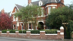A large, historic building with a prominent arched entrance labeled "ASCOT HOUSE." - Ascot House (York)