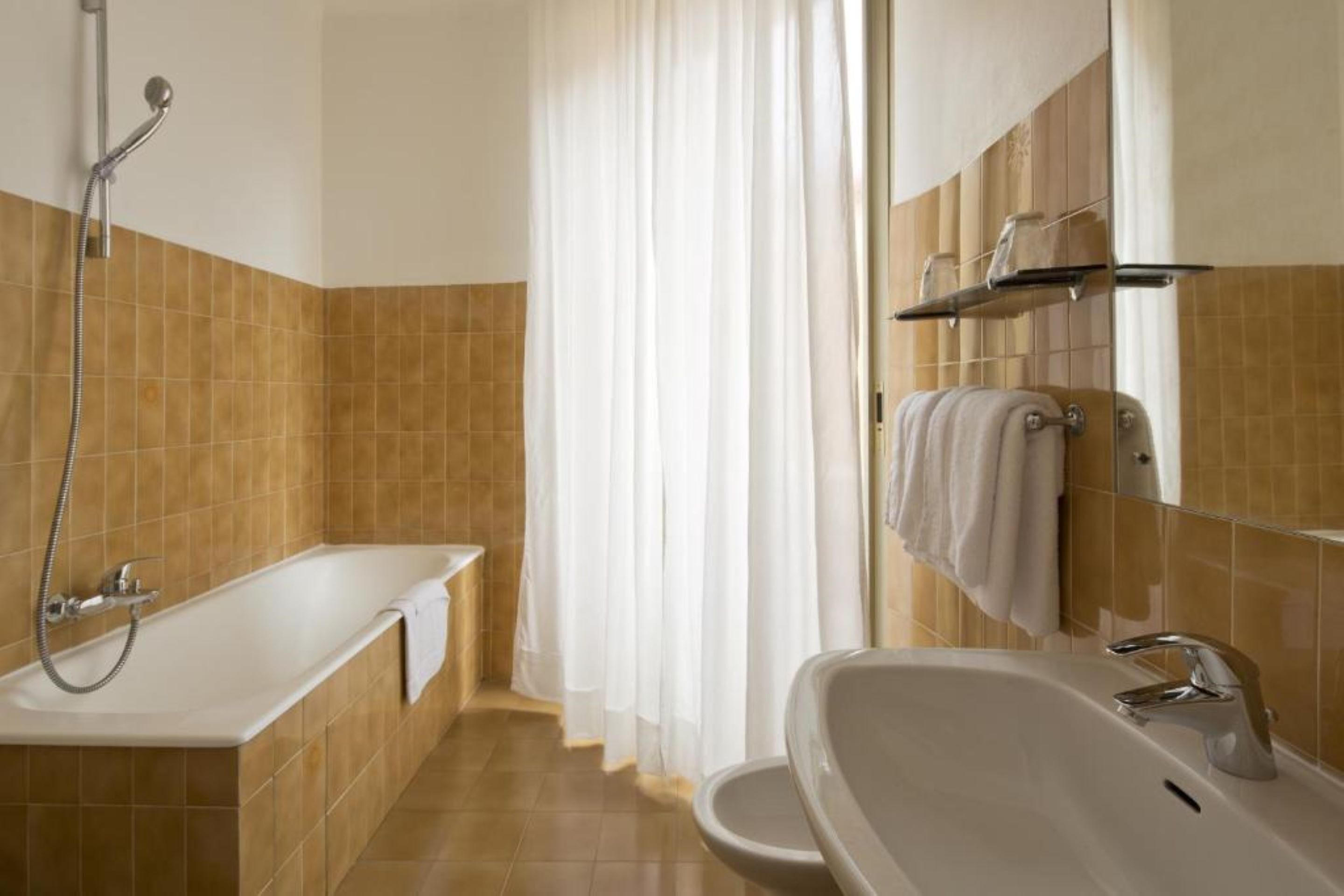 A bathroom with a bathtub, a sink, and a shower.